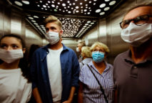 People wearing face mask in elevator