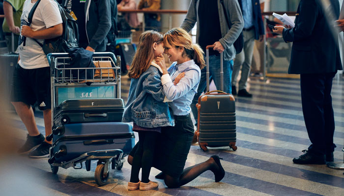 Frau empfängt kleine Tochter am Flughafen; Foto: © Peter Funch/SAS