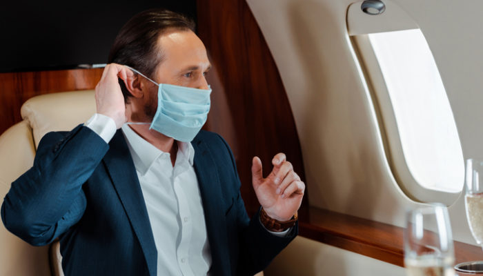 businessman putting on medical mask