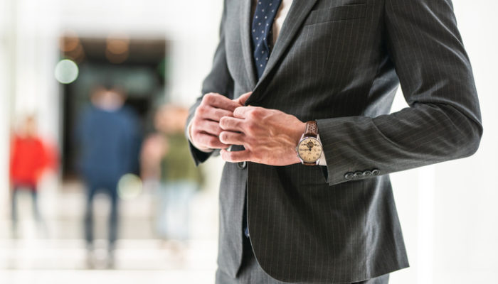 Unrecognizable man in suit with wristwatch